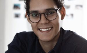 man in black dress shirt wearing black framed eyeglasses